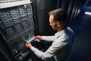 Professional it specialist reducing cyber threats working in server room