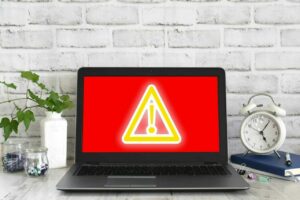 computer screen with red and yellow warning signal for cyber attack