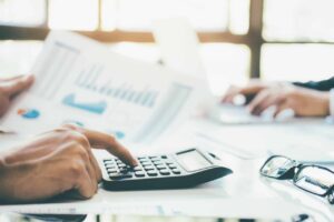 business owners calculating IT budget with calculator