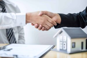 real estate agents shaking hands after good deal