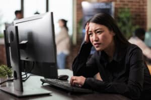 Frustrated woman looking at her computer crash